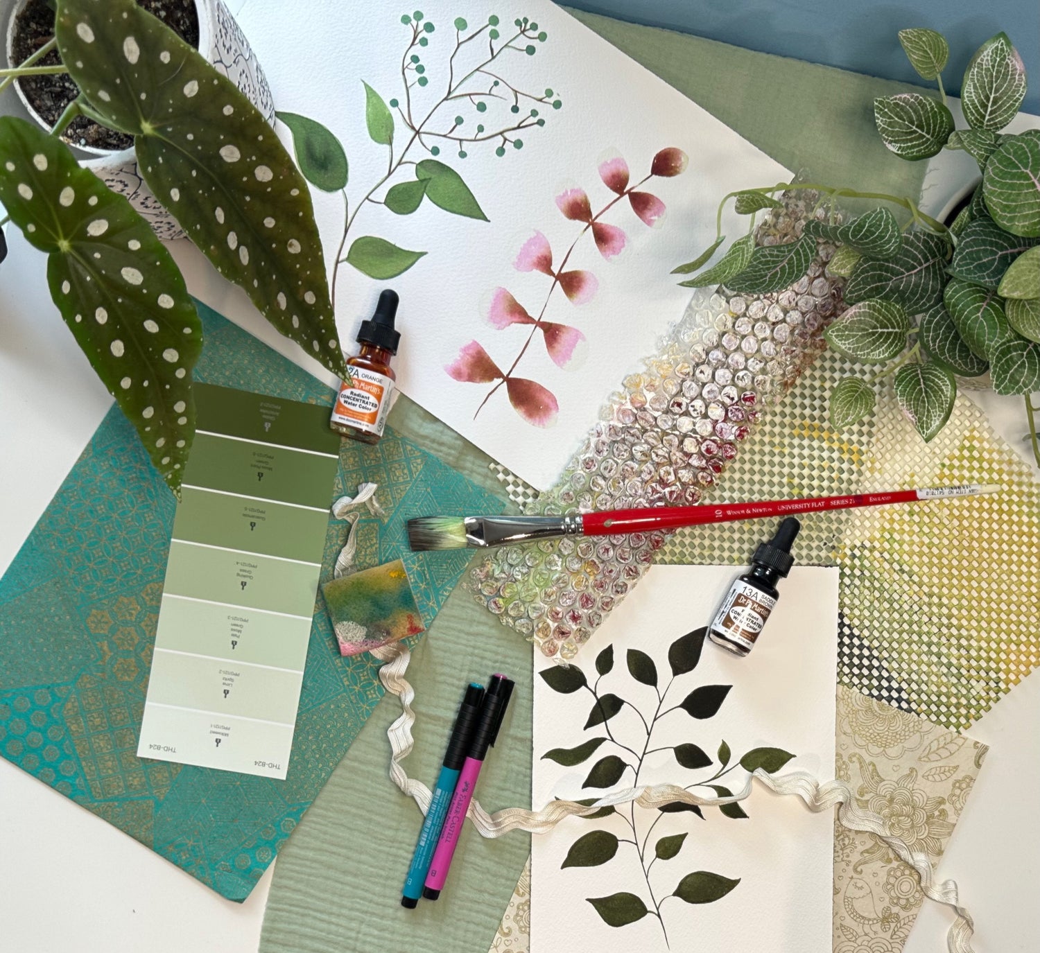 art studio of Tania Herrera from Southern California studio. Art brushes, art supplies, acrylics, inks, watercolor, plants and markers. art creation process